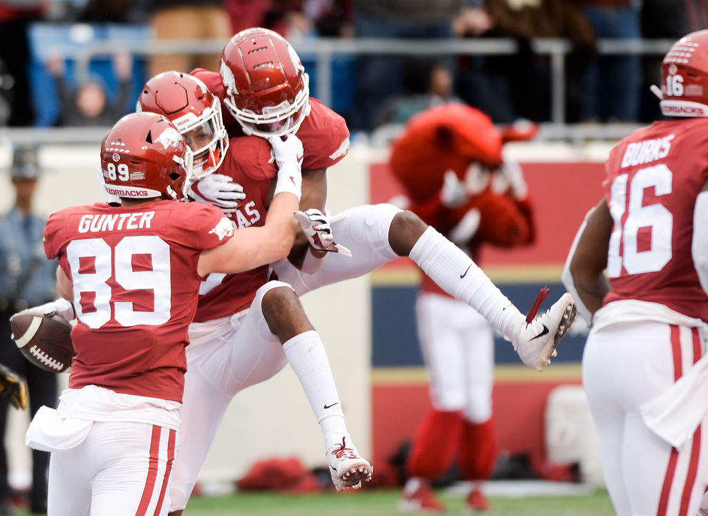 Arkansas players celebrate with wide receiver Trey Knox